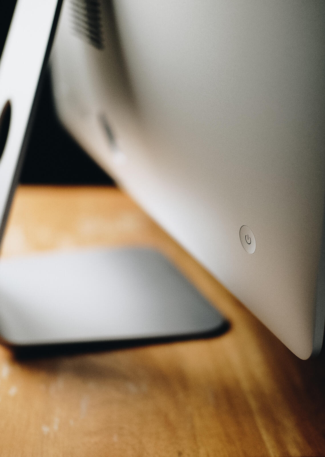 iMac a closeup of the power button on an iMac computer