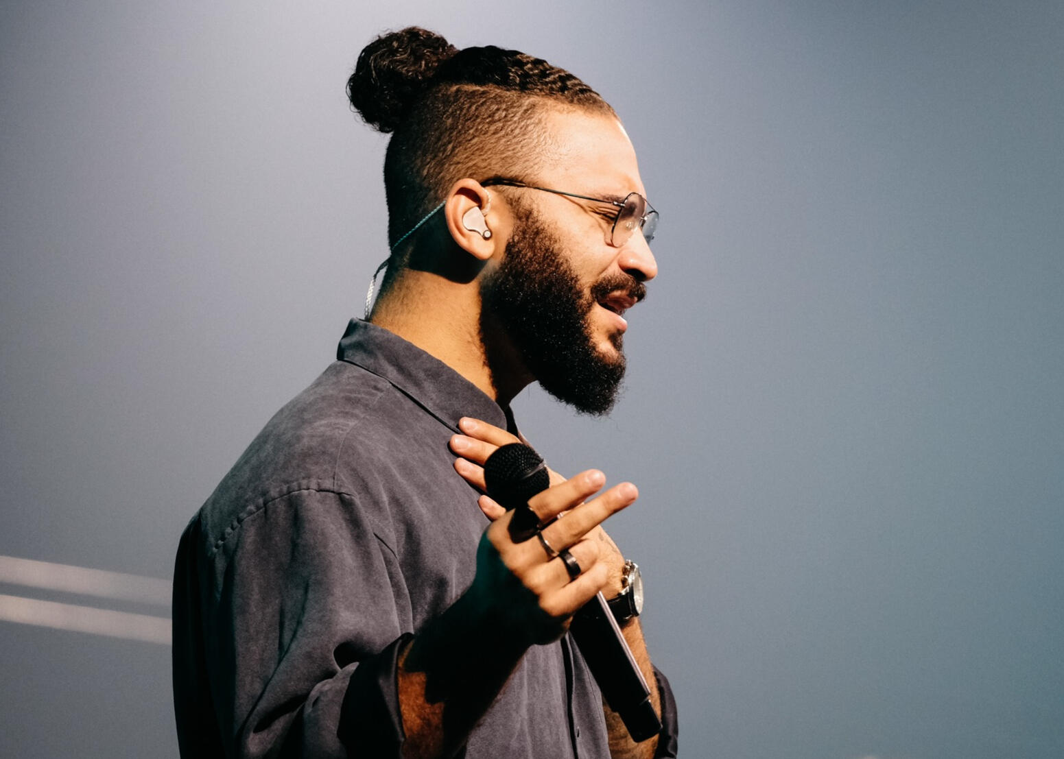 indoor event a man holding a microphone with his eyes closed