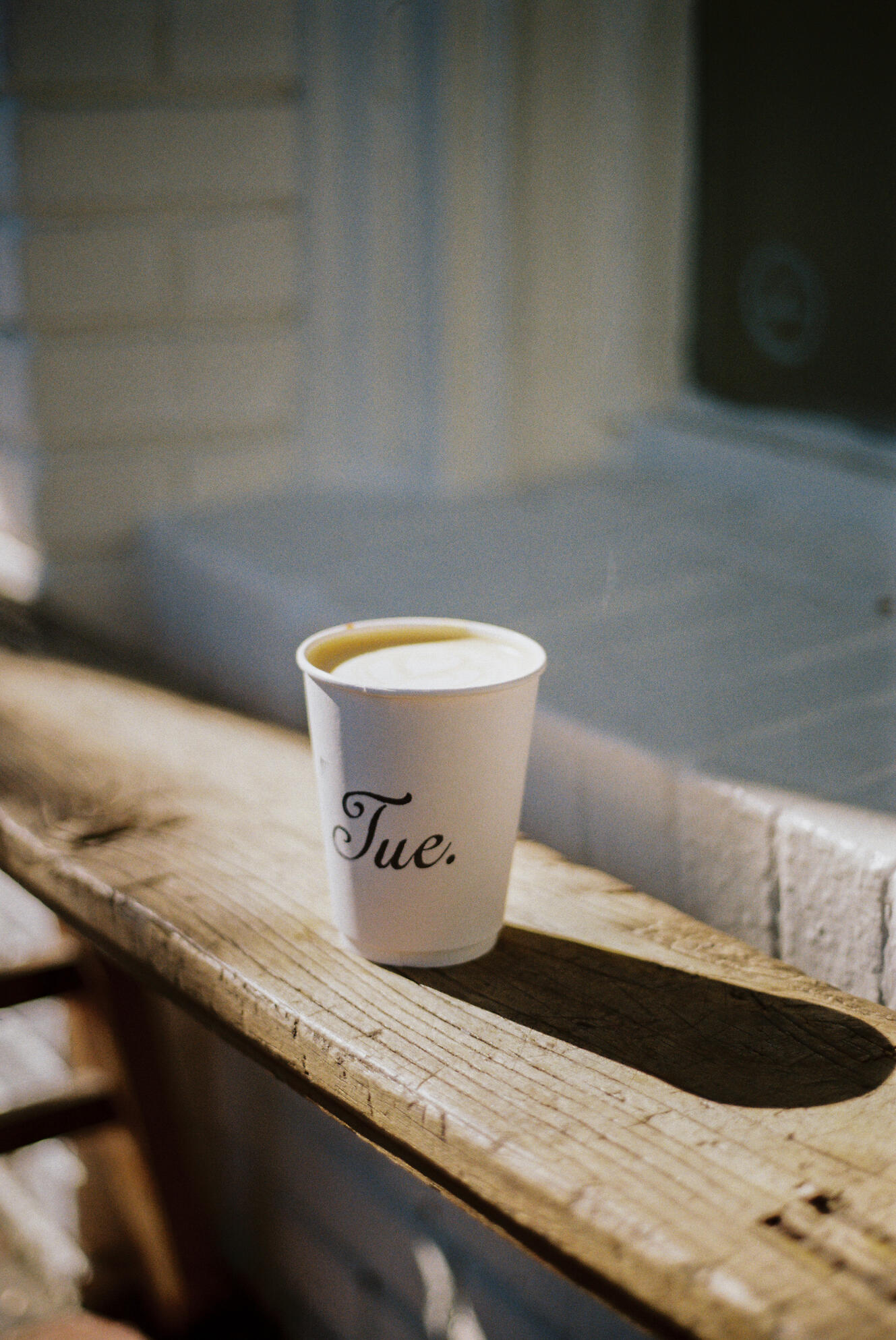 tuesday a cup of coffee on a bench